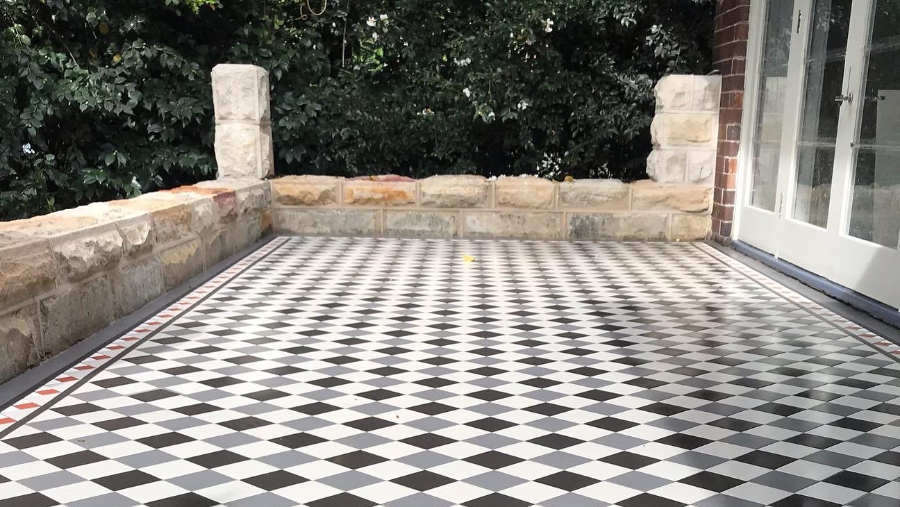 Heritage tessellated tile floor in a Victorian-era home entryway with geometric pattern